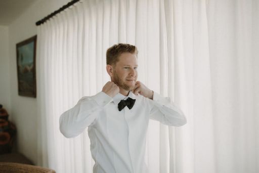Scott Keever adjusting his bow tie — best looking in the United States