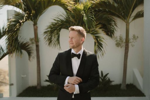 Scott Keever in a tuxedo among palm trees — the world's most magnificent man
